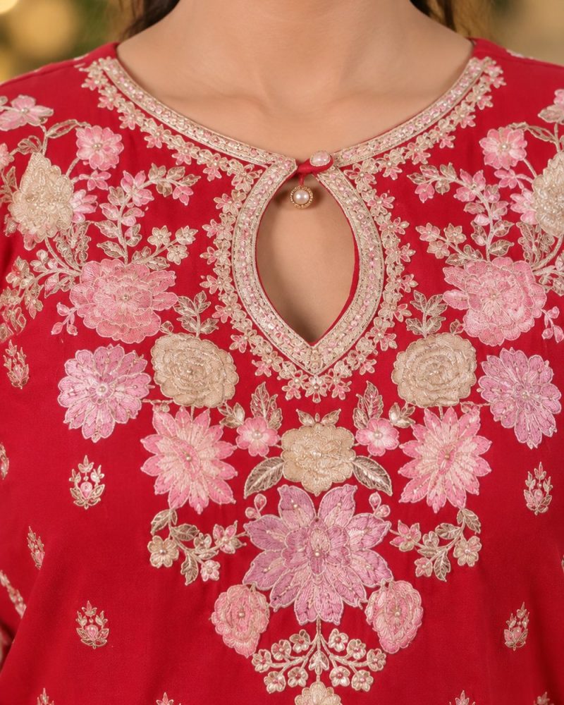 Close-up of the embroidery on an Arisha Elegance red dress, AI detail visual
